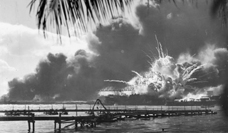 The destroyer USS Shaw explodes as two bombs penetrate her forward magazine